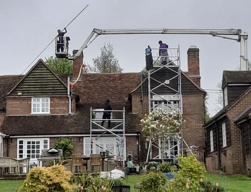 The Roof Moss Cleaners using cherry picker and scaffolding to clean roof safely and professionally in Ludgershall, Wiltshire
